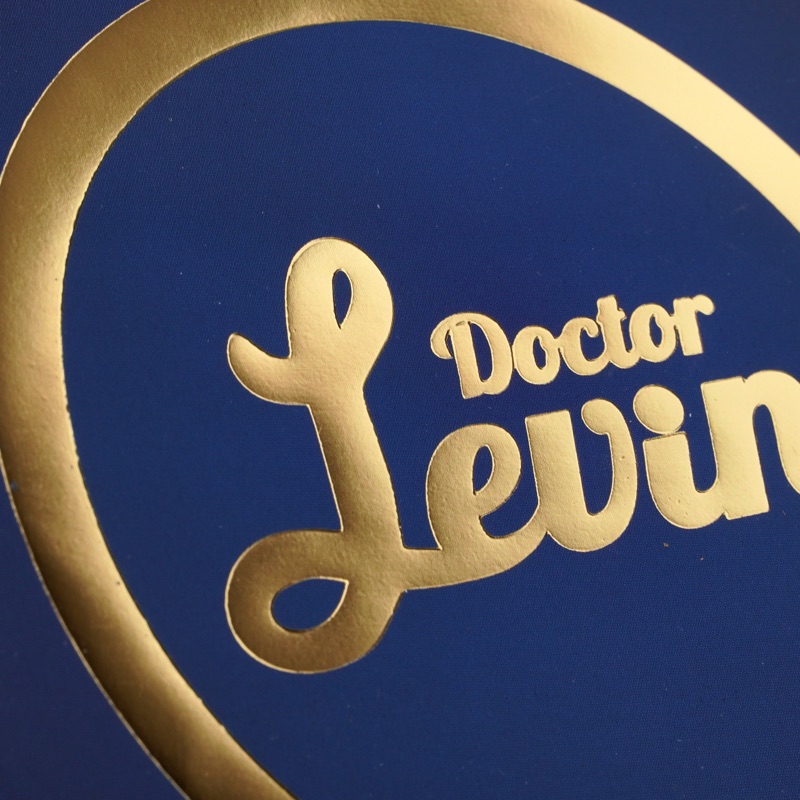 Doctor Levin — крупный план золотого тиснения на синем пакете